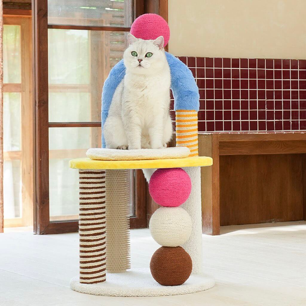 Cat sitting upright on PlayPop Geometric Cat Tree with elevated perch and play features