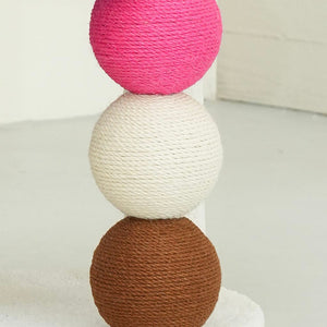 Close-up of pink, white, and brown ball-shaped sisal scratch posts on PlayPop Cat Tree