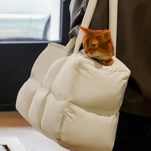 Portable and cozy quilted puffer pet bag with a peek-out opening for small pets, ensuring comfort and security.