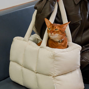 Lightweight and trendy quilted puffer pet carrier with soft handles, perfect for travel and city strolls.
