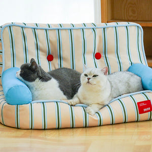 Two cats sharing a wide striped pet bed with armrests – cozy lounge sofa by ZEZE