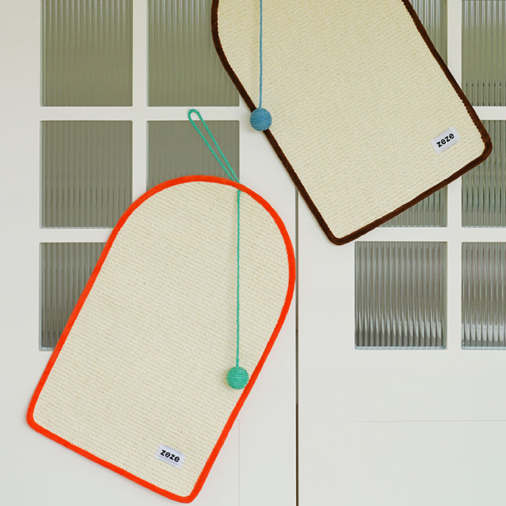 Two Dopamine-Style Cat Sisal Scratching Mats mounted on a door, showcasing versatile usage.
