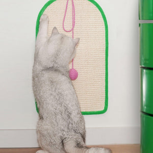 Cat scratching the Dopamine-Style Cat Sisal Scratching Mat mounted on a wall.