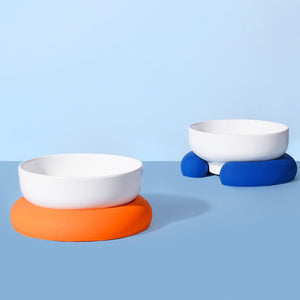 White ceramic pet bowl with blue silicone base, ideal for small pets.
