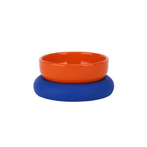 Orange glazed ceramic pet bowl on a blue food-grade silicone base.