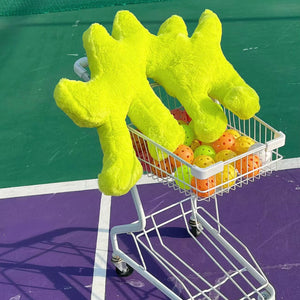 Fluo Green Boom Boom Cat Cushion on a shopping cart full of colorful balls.