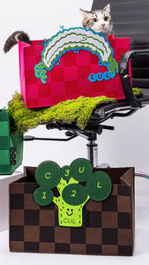 Adorable cat relaxing in a cozy felt bed, adorned with creative patterns.