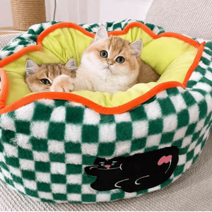 Two kittens cuddled up in a green and white checker pattern pet bed, demonstrating the bed’s deep and snug design.