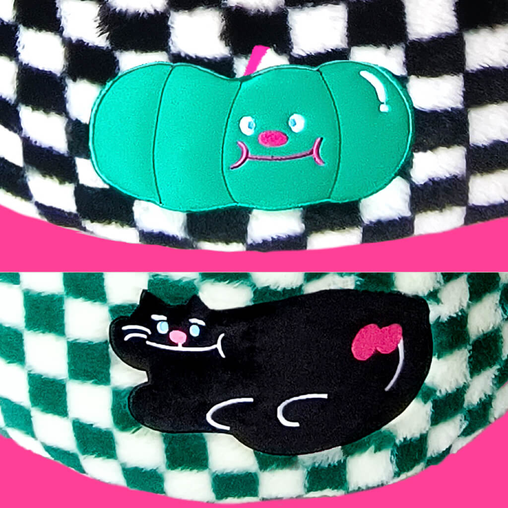 Detailed close-up of the black cat and pumpkin designs on the checker pattern pet beds, highlighting the fun and playful aesthetic.