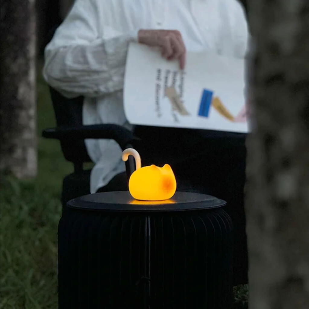Cat Silhouette Tap Night Light on patio table at dusk—portable, cordless mood light with dual brightness, USB-C rechargeable.
