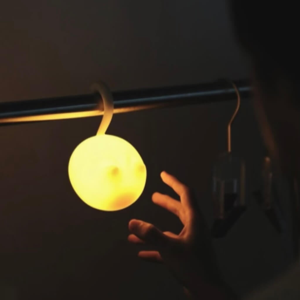 Hanging cat silhouette night light from a rod — flexible cordless use, warm ambient glow, dual brightness.