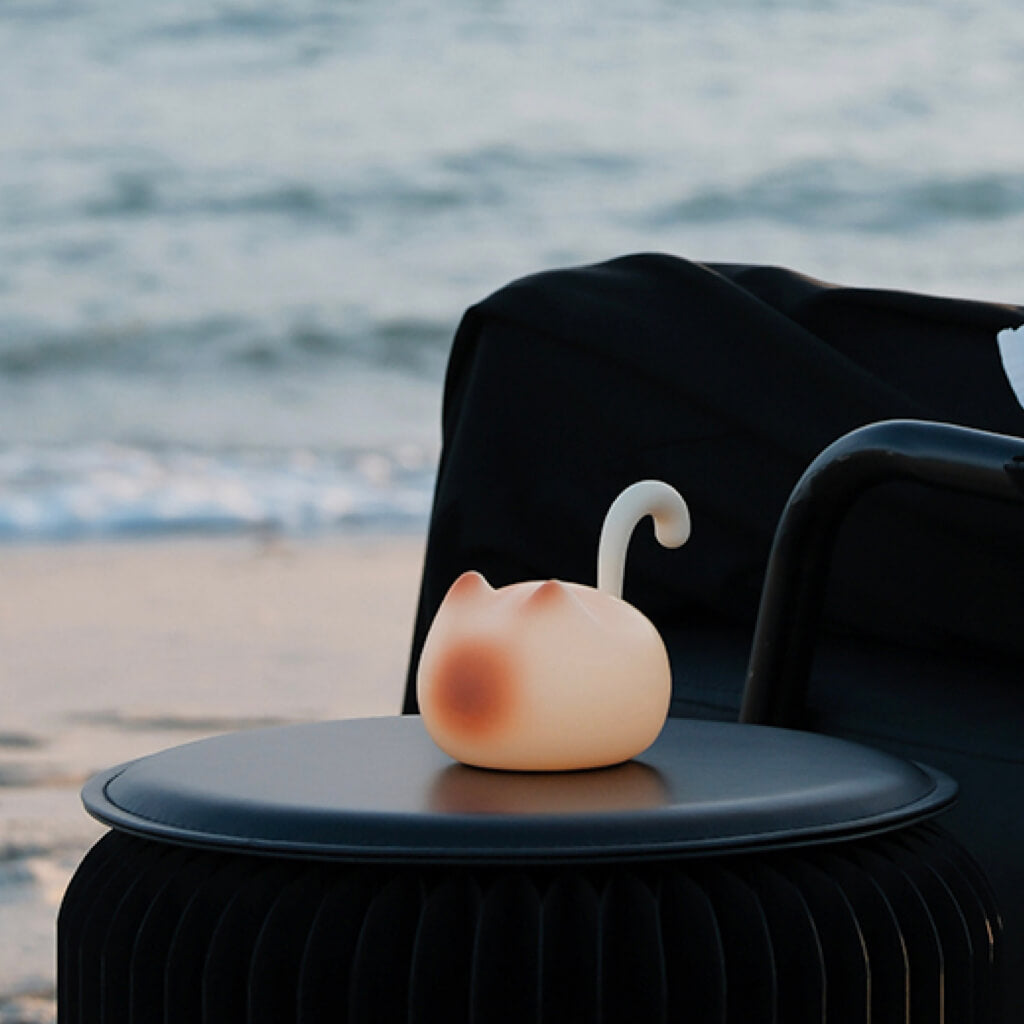 Travel-friendly Cat Silhouette Tap Night Light on seaside table; cordless, soft ambient glow, USB-C rechargeable portable lamp.