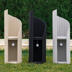Three Time Travel Cat Towers in beige, black, and gray, placed outdoors on a green lawn.