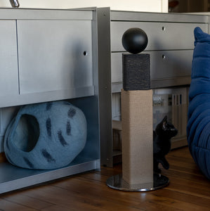 Modern Matchstick Cat Scratching Post displayed in a stylish, minimalist living space with Scandinavian-inspired decor. The scratching post features clean lines, a black wooden sphere on top, and sustainable sisal rope for cats to scratch. Perfect for modern, industrial, or contemporary interiors.