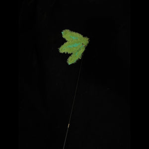 A green bamboo leaf-shaped attachment hanging from the bamboo cat teaser, set against a dark backdrop, ready for playful interaction with your feline.