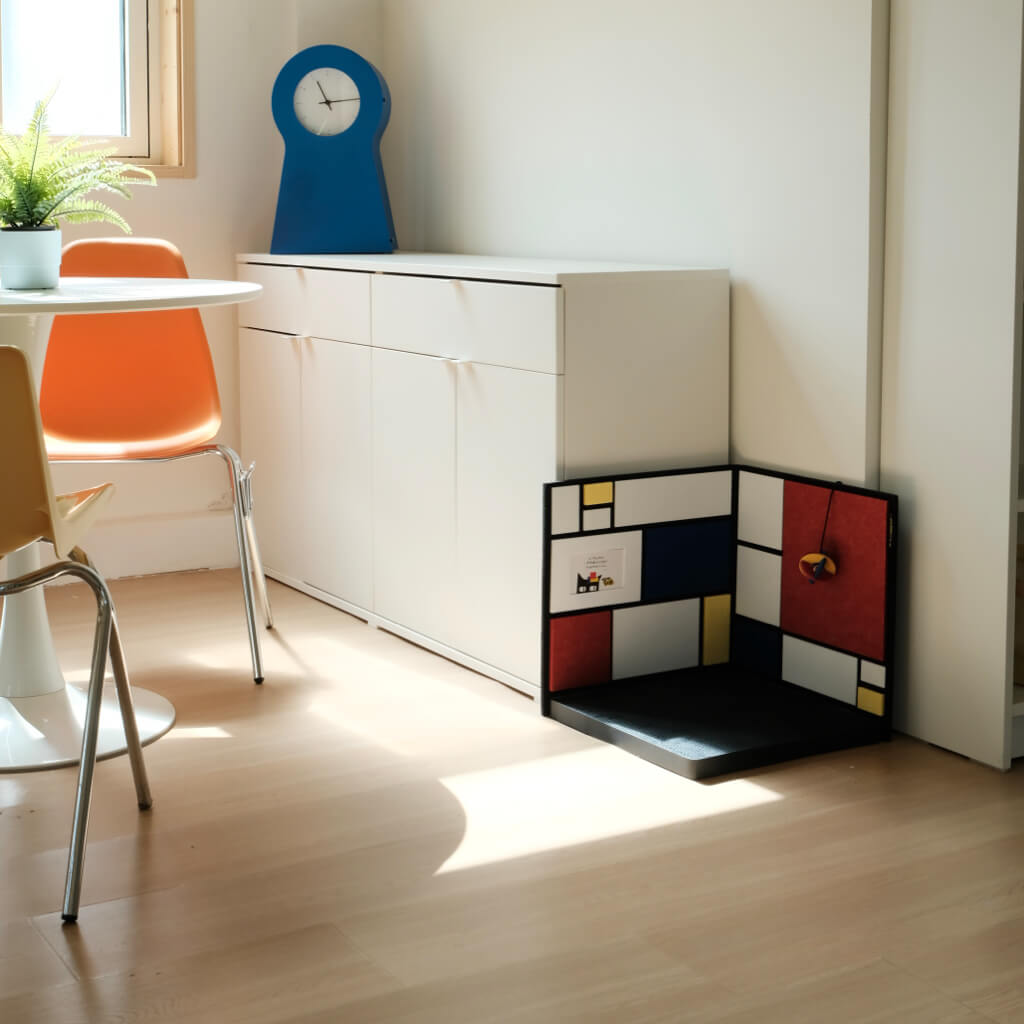 Space-saving corner cat scratcher in bright dining nook — decor-friendly color-block panels and textured base.