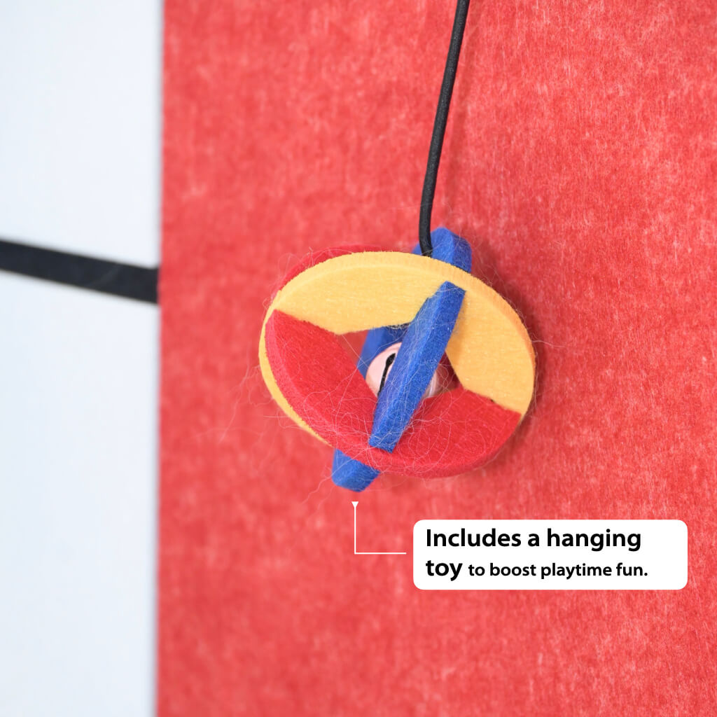 Hanging toy detail on Mondrian-inspired corner cat scratcher—color-block felt panel.