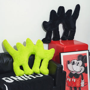 Boom Boom Cat Cushion Black displayed alongside the Fluo Green version in a stylish living room.