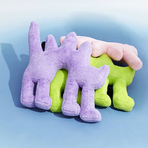 Stack of Gelato Purple, Fluo Green, and Pink Boom Boom Cat Cushions against a pastel background.
