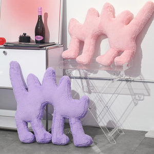 Purple and pink Boom Boom Cat Cushions placed on modern furniture as stylish décor pieces.