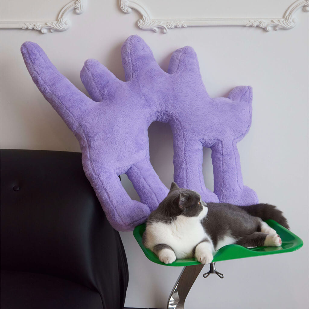 Gelato Purple Cat Cushion with a lounging gray cat beside it.