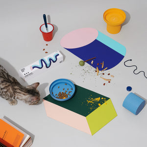 Playful pet dining setup with the Chroma Party Pet Dining Mat and various cat bowls.
