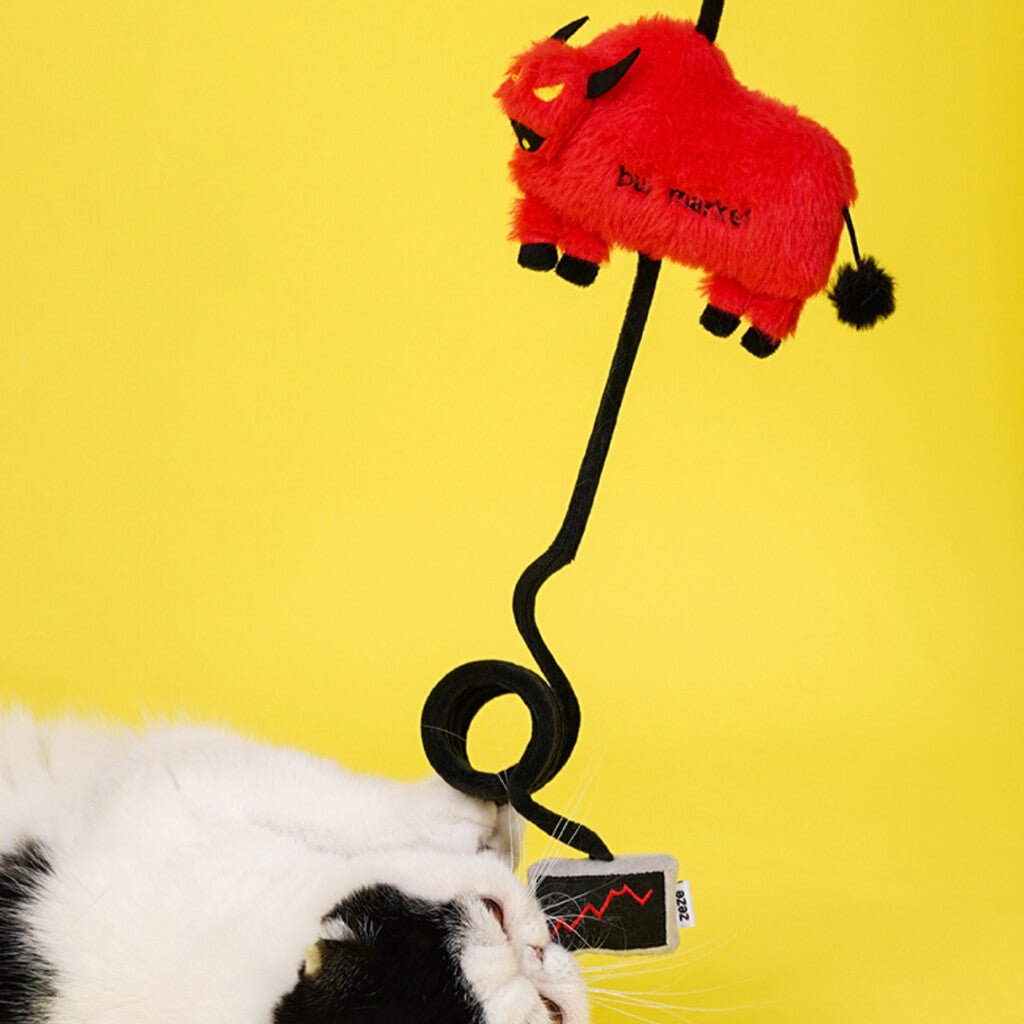 Cat cuddling plush bull toy with coiled spring tail and catnip screen detail