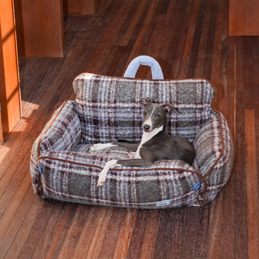 Gray and light blue plaid bolster pet sofa bed with carry handle—cozy ZEZE dog & cat couch on wooden floor.