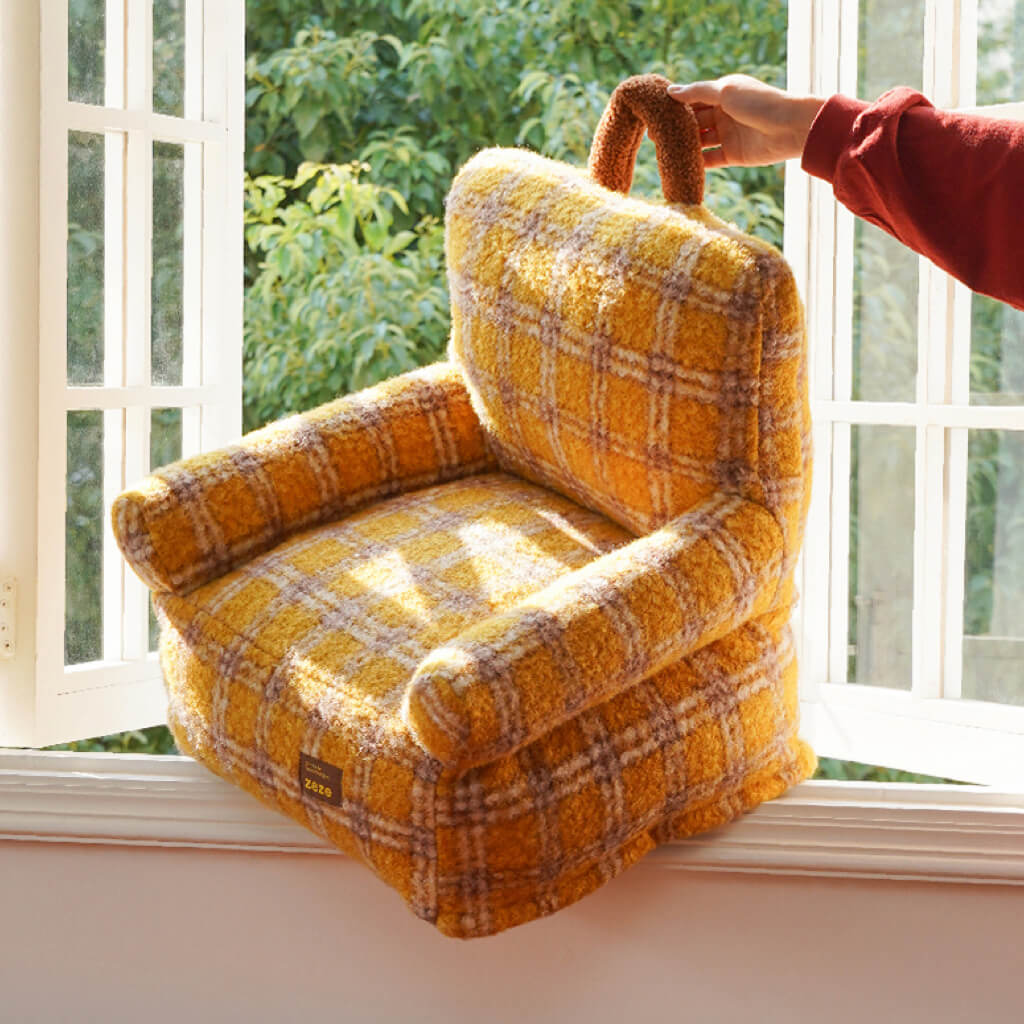 Portable ZEZE yellow plaid armchair pet bed—hand lifting the soft carry handle; lightweight, bolstered couch for cats & dogs.