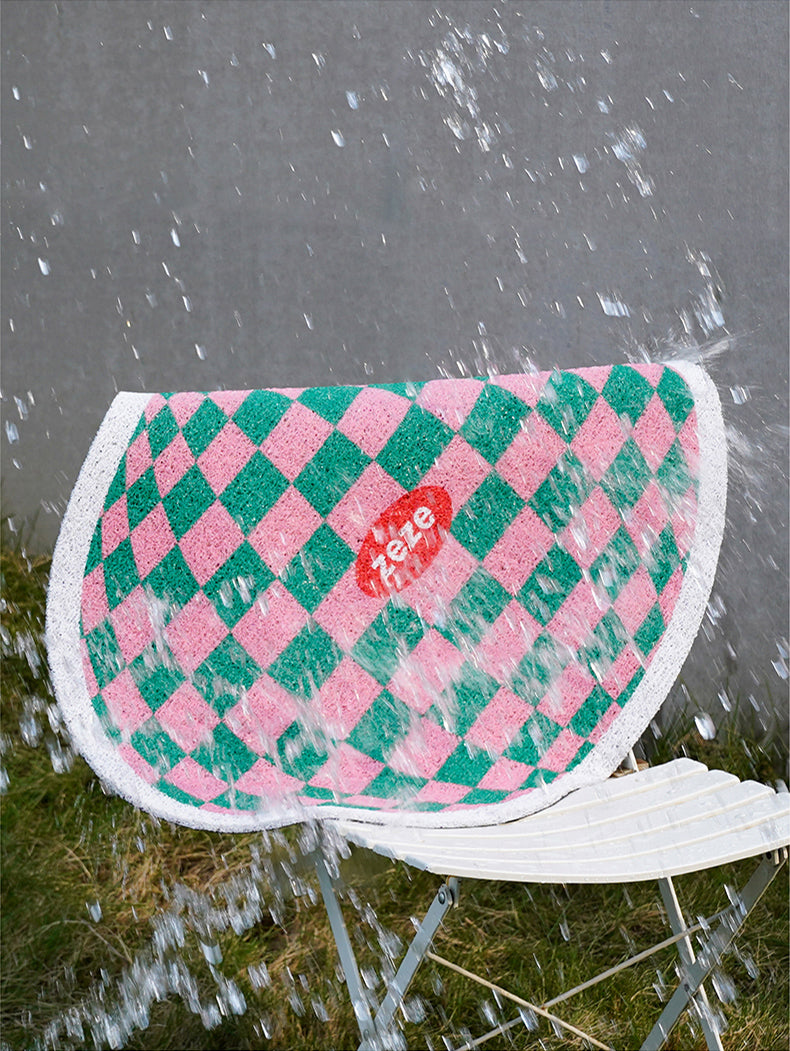 Design Plaid Litter Mat in Pink and Green Being Washed Outdoors.