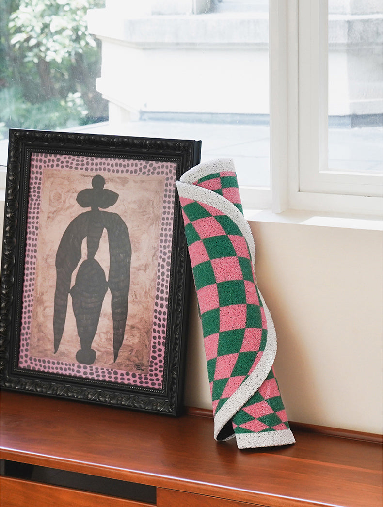Design Plaid Litter Mat Rolled Up and Styled with Home Decor.
