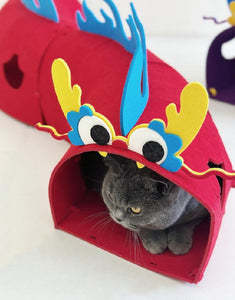 Gray cat inside a red dragon-themed felt tunnel toy - Dragon Edition Cat Felt Tunnel.