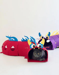 Cat lounging inside a red dragon-themed felt play tunnel - Interactive Cat Felt Tunnel - Dragon Style.