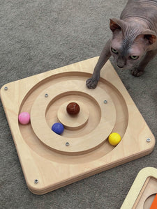 Sphynx cat engaging with the Wooden Cat Turntable Toy, moving the colorful ceramic balls around the circular track, perfect for keeping cats active and entertained.
