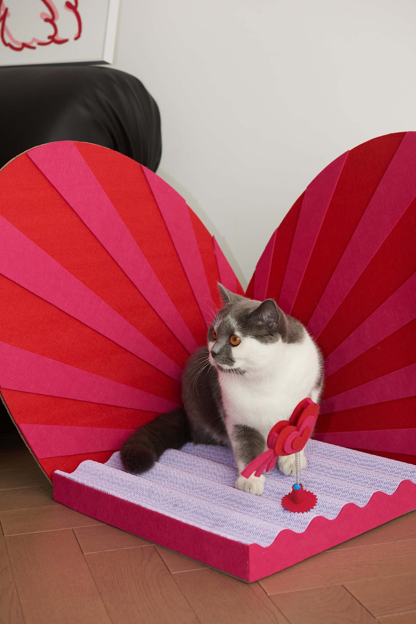 Love me, love my cats heart-shaped scratcher, ideal for felines who love a good scratch.
